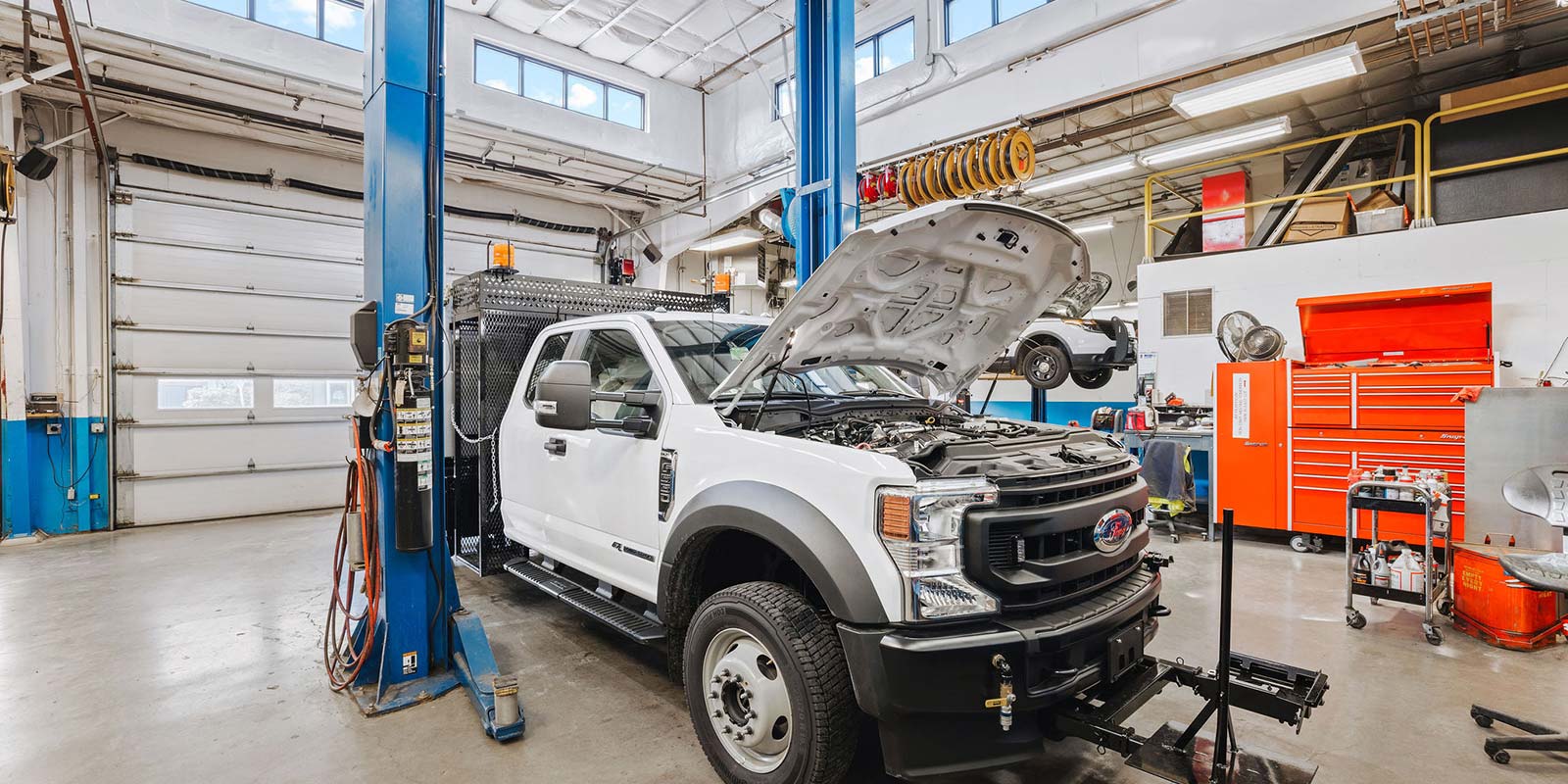 the interior of the NUD garage with a truck with the hood popped.