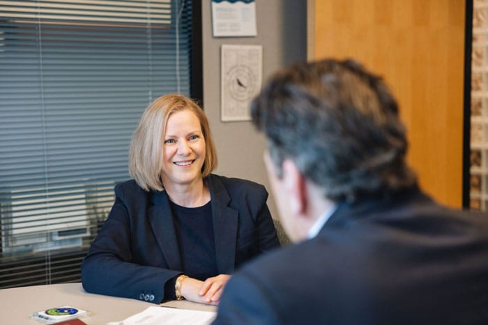 a man and woman sitting in an office