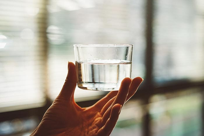 a short glass of water filled about half way up